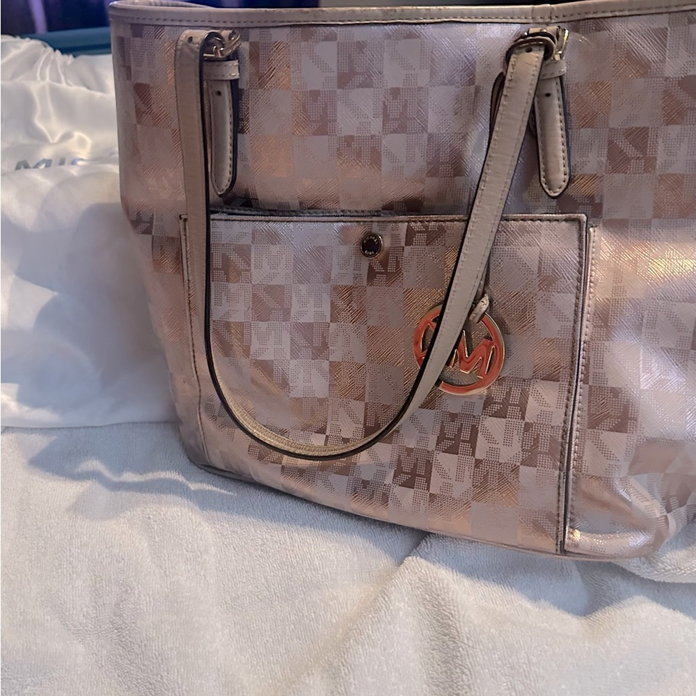 Micheal Kors bag rose gold color.